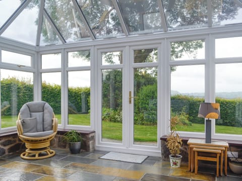 Spacious conservatory with access to garden | Green Lane Cottage, Aberhafesp, near Newtown
