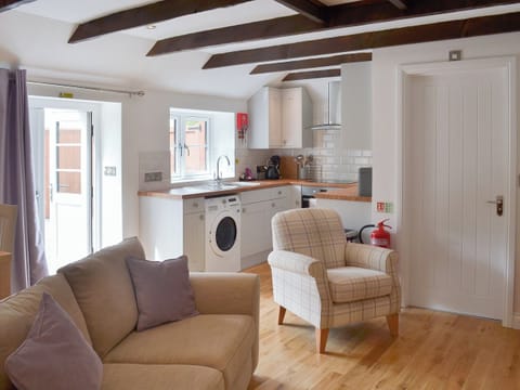 Wood-floored living area with access to the garden | Bluebell Cottage, Over Stowey, near Taunton