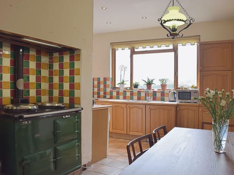 The tile-floored kitchen diner has an Aga as well as a breakfast area | Tan Y Castell, Llanmill, near Narberth