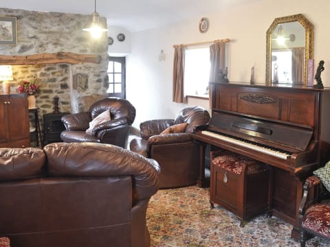Living room with inglenook fireplace and period furniture | Cae Bach Cottage, Dinas, Lleyn Peninsula