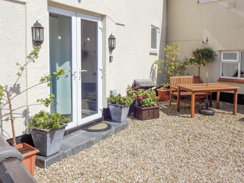 Gravelled courtyard with outdoor furniture | The Snug - Ty Copr, Pen-y-Sarn, near Amlwch