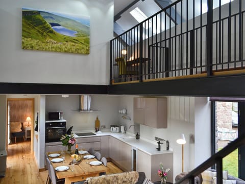 Open plan living space with beams and oak floors | Maes Merlin, Llanddeusant, near Llangadog