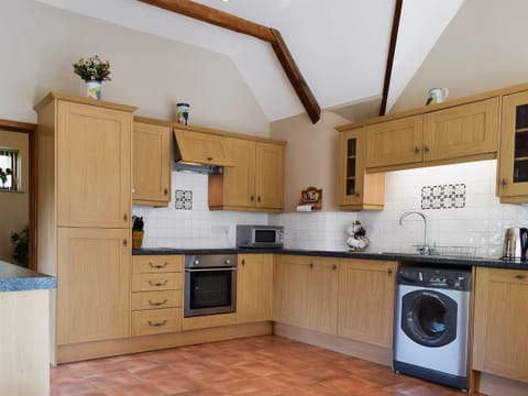 Large kitchen/dining room with terracotta tiled floor and French doors | Alfie’s Barn, Ambrosden