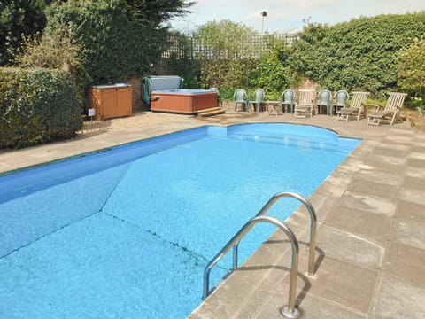 Large outdoor solar panel heated swimming pool with Hot-tub and poolside seating | Greenlands Farmhouse, Barmby Moor, York