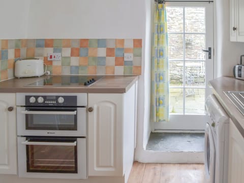 Kitchen with direct access to the patio | Meadwell - Trebarwith Farm Cottages, Trebarwith, Delabole