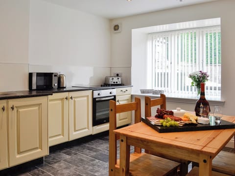 Spacious kitchen with attractive dining area | Kirroughtree Steading 1 - Kirroughtree Steading Holidays, Newton Stewart