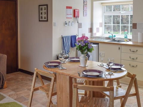 Open plan living area with modest dining table and chairs | Sycamore Cottage, Borrowby, near Staithes