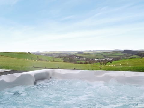 Relaxing hot tub with wonderful views of the Welsh country side | No 4 Pengraig Draw - Pengraig Cottages, Near Llanfarian