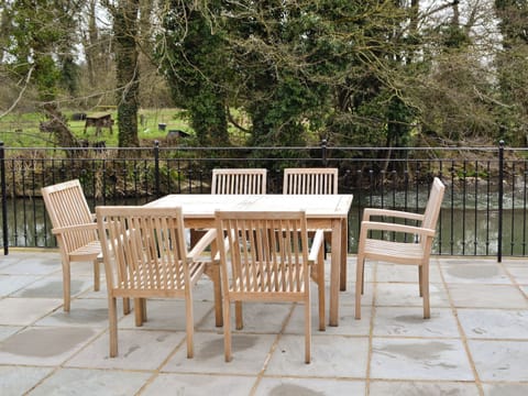 Chairs and table provided for sitting out on the terrace | Herons&rsquo; Weir - Jeffries Mill Cottages, Spring Gardens, Frome