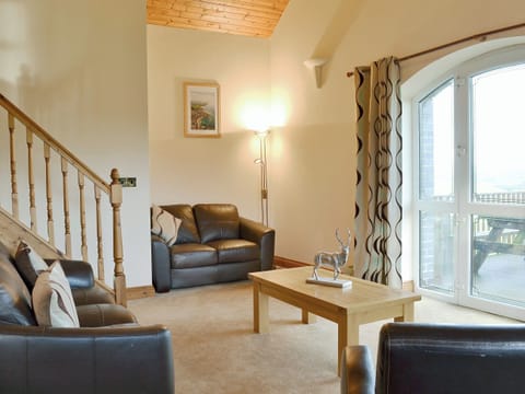 Spacious living room with doors leading onto decking area with views to the surrounding area | No 5 Pengraig Draw - Pengraig Cottages, Near Llanfarian
