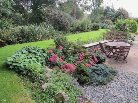 Well stocked garden with delightful table and chairs | Garries Cottage, near Bassenthwaite