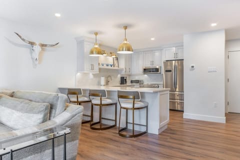 Bright, open kitchen with stylish island seating and modern appliances