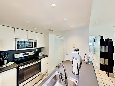 Indulge in our fully equipped kitchen featuring state-of-the-art Vitamix, Nespresso & Keurig Coffee Makers, Soda Stream, full-size stove, oven, microwave, fridge, dishwasher, and laundry machine with dryer.