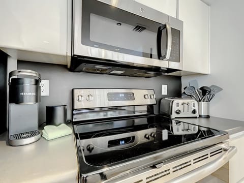 Modern Kitchen Haven - Discover the full-size kitchen with a bar, equipped with Nespresso and Keurig coffee makers, toaster, Soda Stream for sparkling waters, and Vitamix for the perfect health drinks.