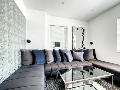 Relax in the bright living room with a large 75-in Smart TV and an oversized window offering a partial city view, away from any street noise.