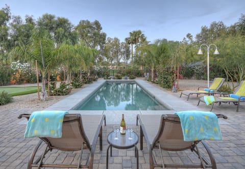 SCOTTSDALE SUNDOWN has a pool with comfy lounge chairs and and an amazing view of the Starfire Golf Course.