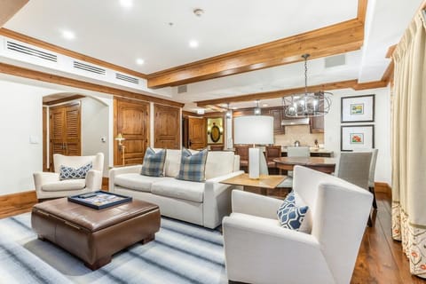 Spacious living room with cozy seating and elegant wood accents