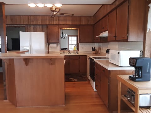 Kitchen with dishware and cookware for a crowd.