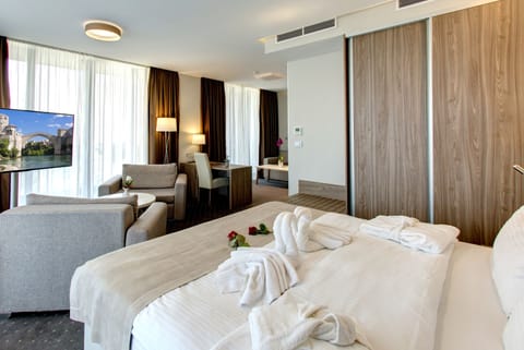 Suite, Balcony, City View | Minibar, in-room safe, desk, blackout drapes
