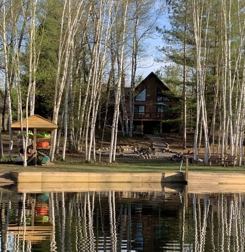 House from canal.  5/24/2023. House is now painted dark green.