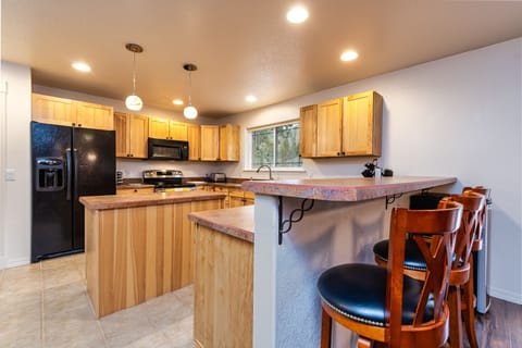 Kitchen with island and plenty of space and cabinets.