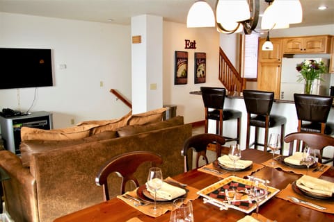 Dining room table in great room, seats 6 plus 4 barstools.