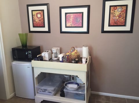 Small fridge and microwave. Coffee maker and kettle.