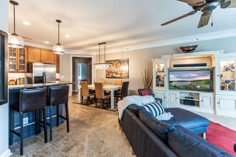 Front door view. White cabinet houses Smart TV, sound bar, blue ray, and DVD's.