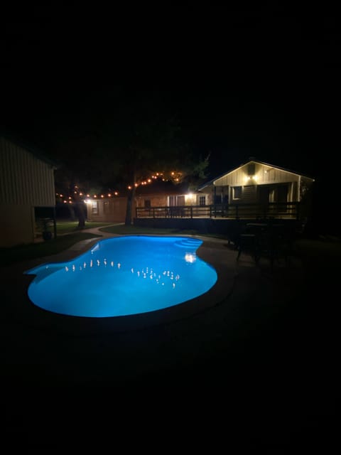 Back of pool facing house on right and bunkhouse on left