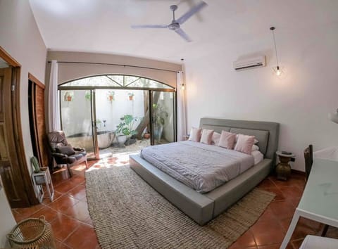 Bedroom with stone Balinese tub and private bathroom.