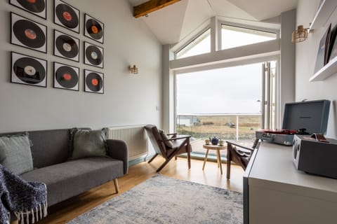 Upstairs music room with additional seating, unique amenity at pet-friendly holiday home sleeping eight in Rhosneigr, Anglesey