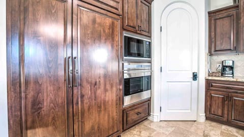 Seamless paneled fridge w/ built in oven in large kitchen