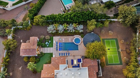 Aerial view of estate with pool, hot tub, pickleball & lush landscaping!