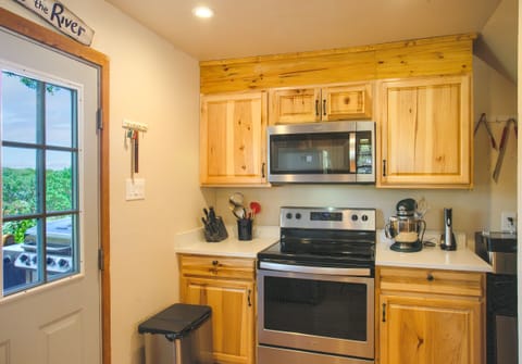 Newly remodeled kitchen fully stocked with cookware, utensils and serving ware.