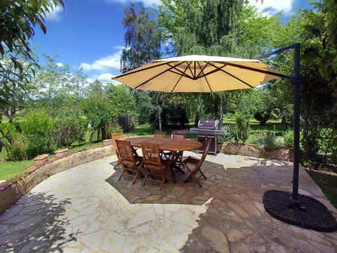 Gorgeous back yard with huge patio for al fresco dining, entertaining & grilling