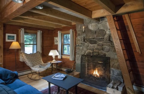 Cozy living space with fieldstone fireplace.