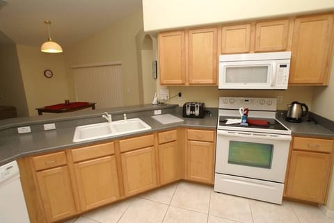 Fully equipped kitchen with ice-making fridge for your culinary enjoyment