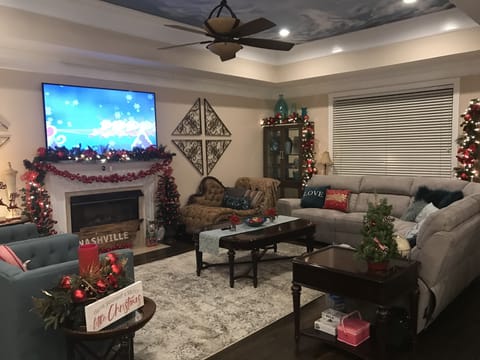 Spacious family room with massage chair, reclining couch.