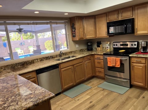 Bright and cheery kitchen and dining with views of the pool!