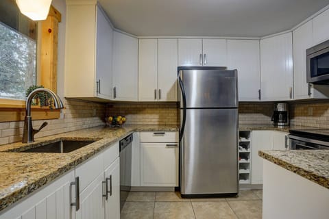 Granite countertops and a full array of appliances in the kitchen.