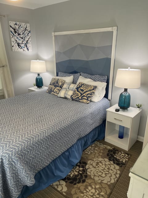 Bright, sunny bedroom with lovely, pristine, white end tables