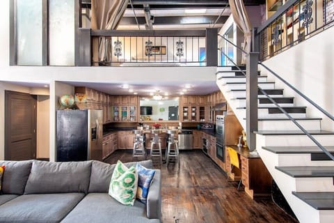 View into Spacious Kitchen & Stairs to Bedroom