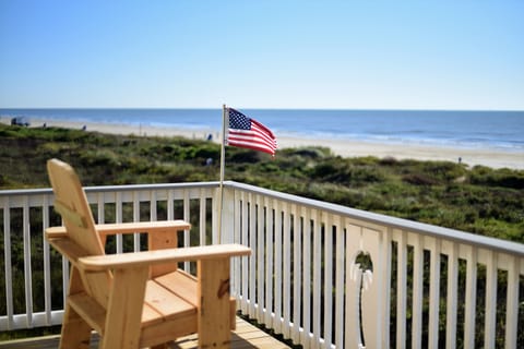 Unmatched view. Four tall wooden chairs, table and two rocking chairs provided.