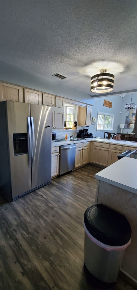 Open concept kitchen with updated stainless steel appliances.