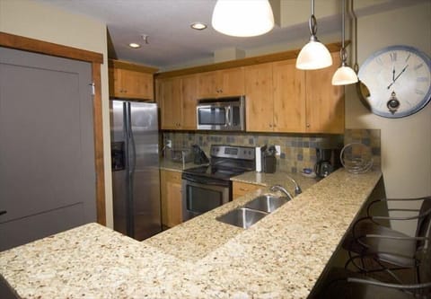 Immaculate full kitchen with stainless steel appliances and granite countertop