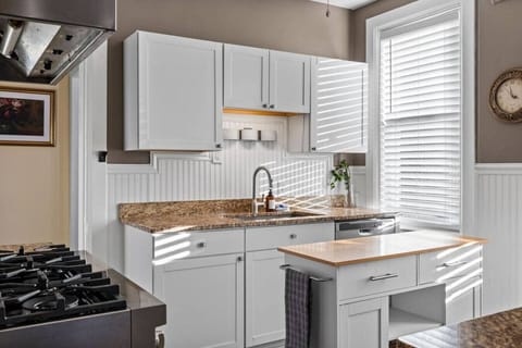 Bright Mornings Begin Here – A sun-drenched corner of the kitchen welcomes you each day with warmth, filtered light, and modern charm.