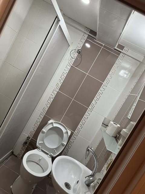 Shower, hair dryer, slippers, towels