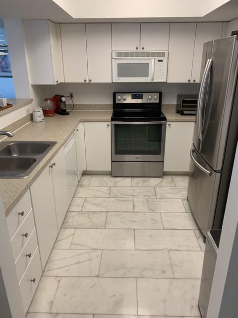 Full Kitchen with Silverware, Plates, Coffee Machine, Boiler and Toaster Oven.