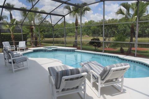 Pool and pool deck which overlooks a small lake to the rear. Note the privacy.