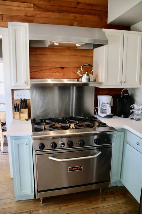 Commerical 6 burner gas stove with oven, tea kettle and 2 coffee makers.
